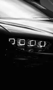 A black and white photo of a car's headlights